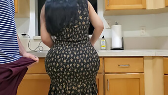 A Well-Endowed Stepson Receives A Passionate Kiss From His Busty Stepmom In The Kitchen